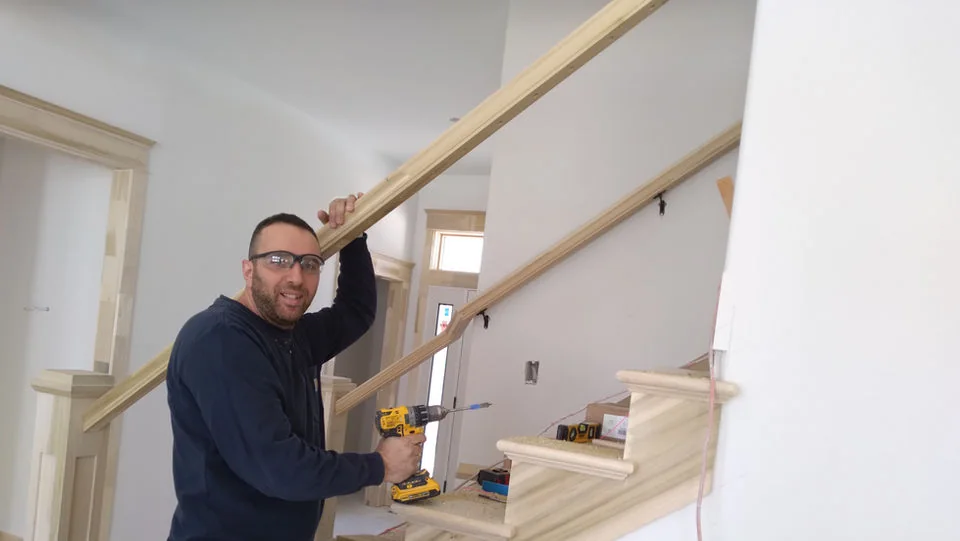 Craftsperson fitting a stair rail