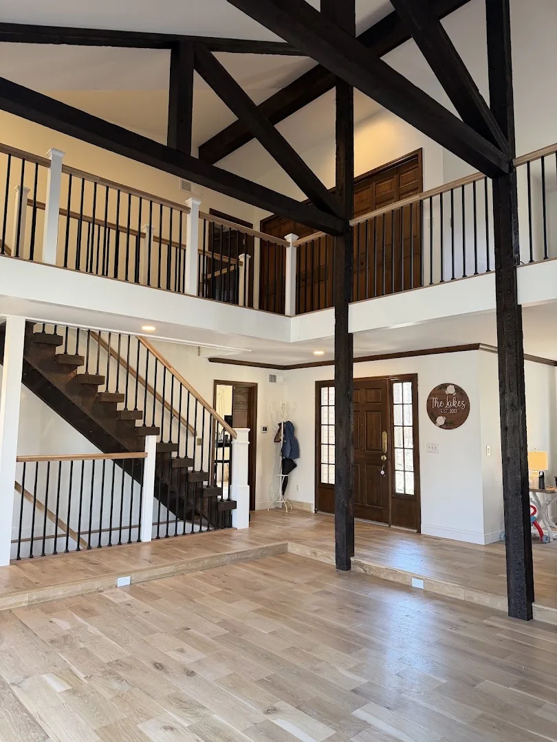 Open foyer with custom stair and dark railings